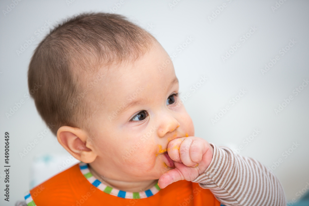 Baby laughing during lunch time. (6 months old). Baby laughing during lunch time. (6 months old).