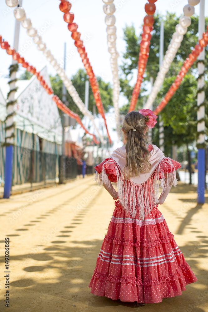 Girl in traditional flamenco dresses dance during the Feria de Abril on April Girl in traditional flamenco dresses dance during the Feria de Abril on April