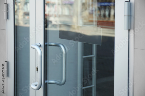 White glass door with sign on it, closeup