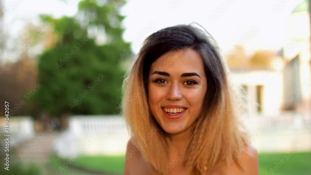 Attractive girl looks at camera and makes faces during photosession. Attractive girl looks at camera and makes faces during photosession.