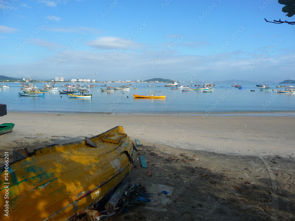 the wrecked boat in the beach, the sea with many boats good and bad