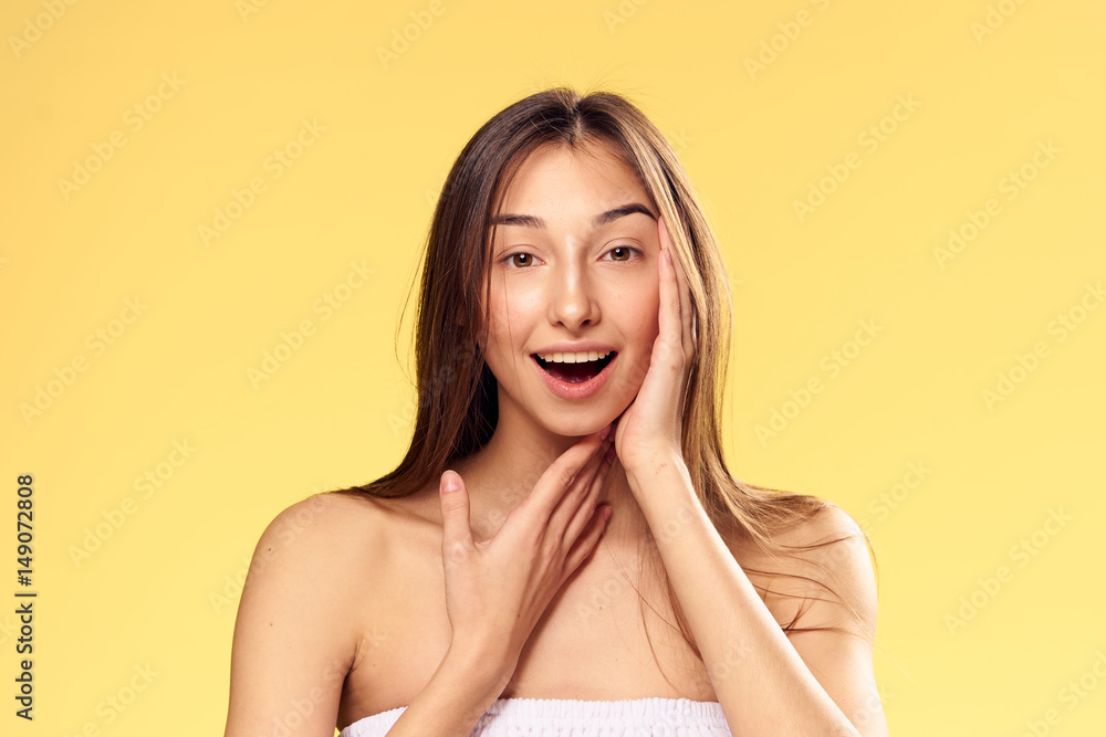 happy woman on a yellow background, joy, tender skin, spa