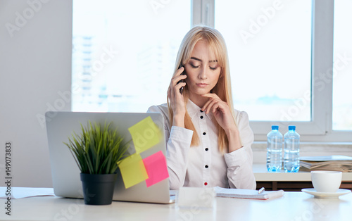 business woman in the office talking on the phone