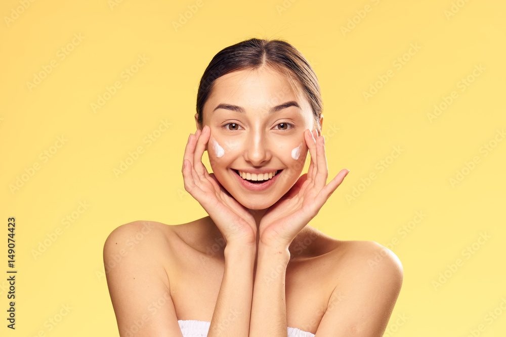 brunette with dark eyebrows and moisturizer on her face brunette with dark eyebrows and moisturizer on her face