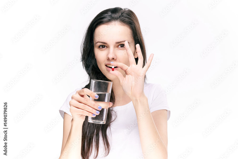 woman with a pill and a glass of water woman with a pill and a glass of water