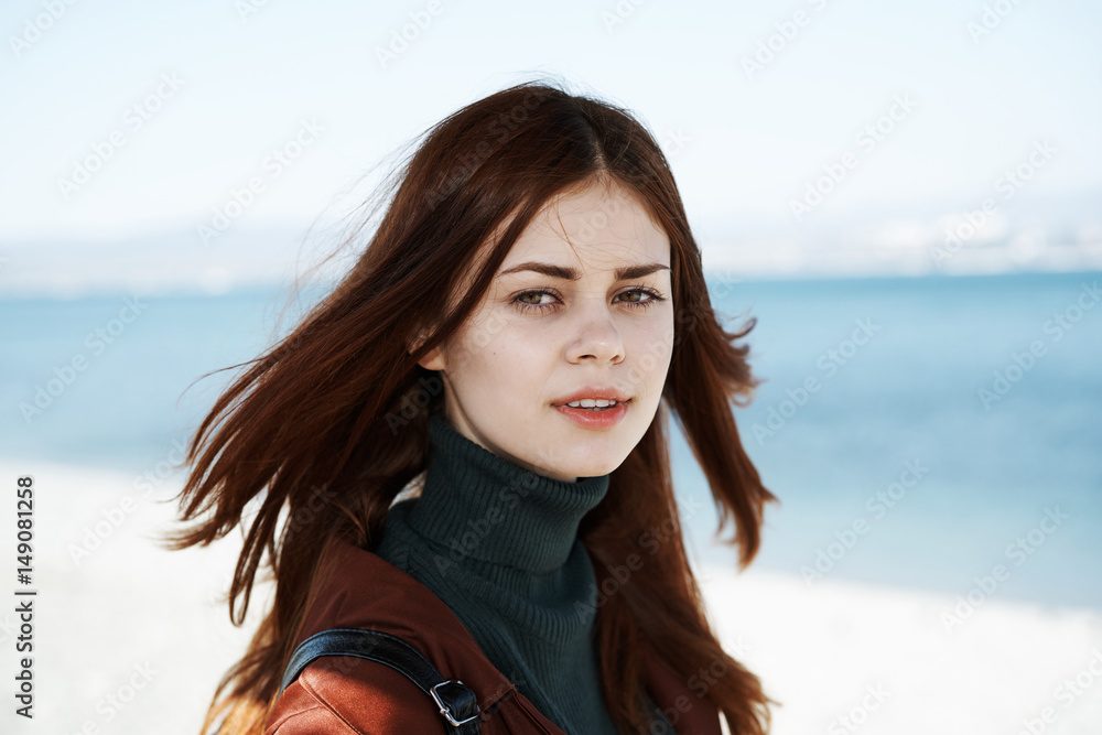 a woman is walking along the shore a woman is walking along the shore