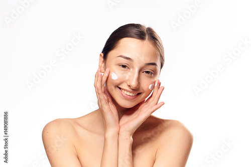 young woman with cream on face
