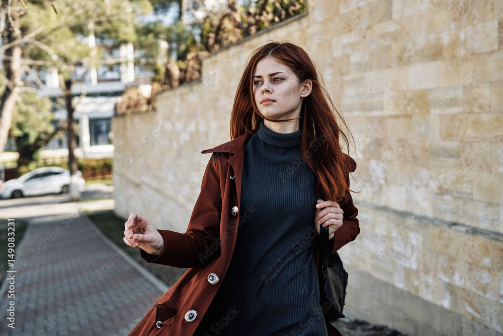 a young lady is walking along the street, autumn season a young lady is walking along the street, autumn season