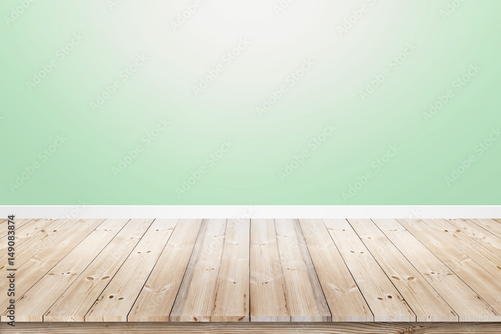 Empty room interior with soft green concrete wall and wood floor Empty room interior with soft green concrete wall and wood floor