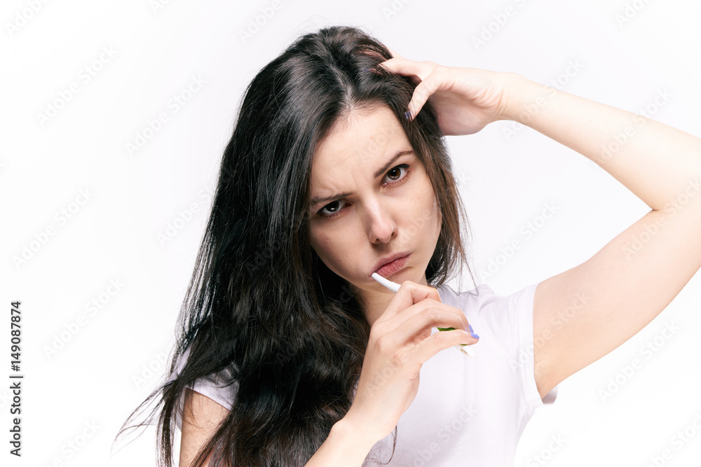 brunette brushes teeth on a light background brunette brushes teeth on a light background