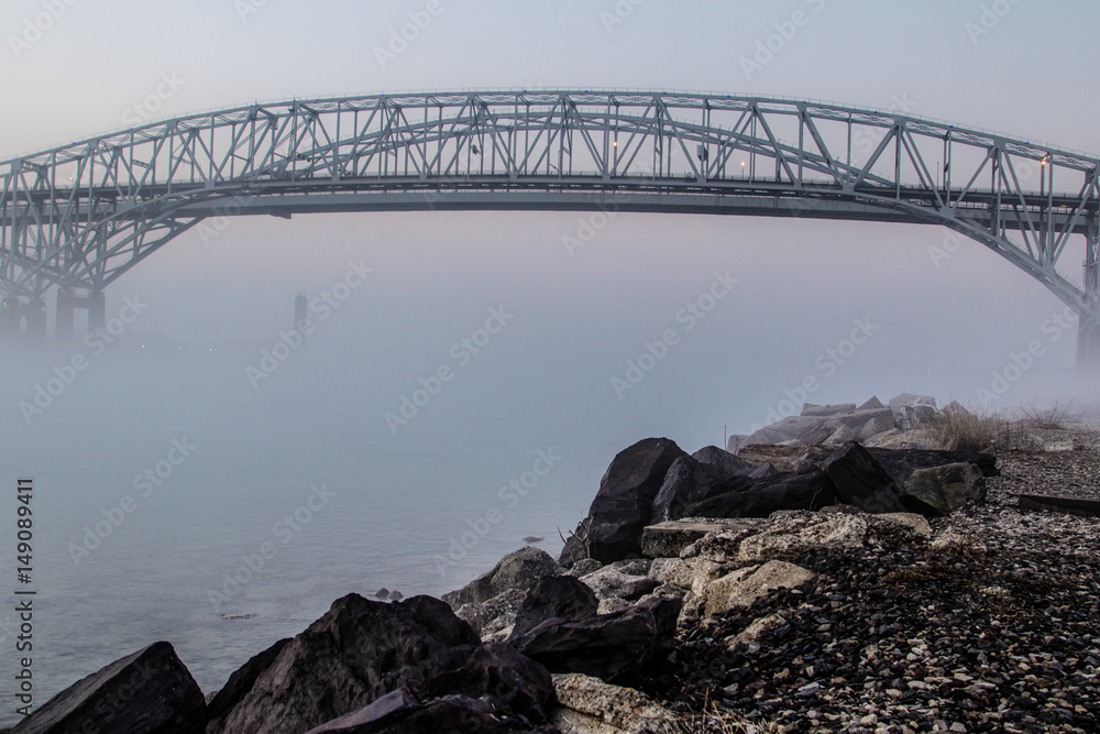 Obraz premium Blue Water Bridges. The twin spans of the Blue Water Bridges encased in fog. The international border connects the Sarnia, Ontario, Canada with Port Huron, Michigan, USA.