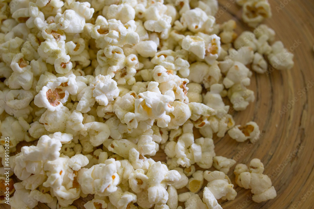 Popcorn in white bowl closeup on wood table Popcorn in white bowl closeup on wood table