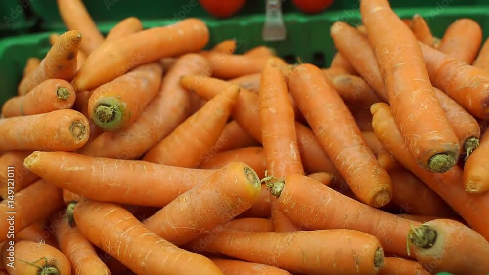 Fresh carrot in the grocery store. Box of carrots in the supermarket, close-up. Fresh carrot in the grocery store. Box of carrots in the supermarket, close-up.
