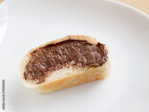 Piece of french bread with chocolate peanut butter