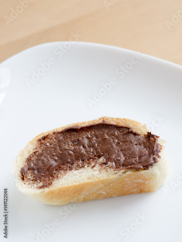 Piece of french bread with chocolate peanut butter