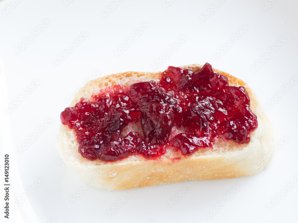 Piece of french bread with cherry jam Piece of french bread with cherry jam