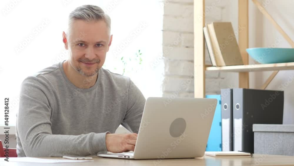Middle Aged Man at Work Smiling toward Camera Middle Aged Man at Work Smiling toward Camera