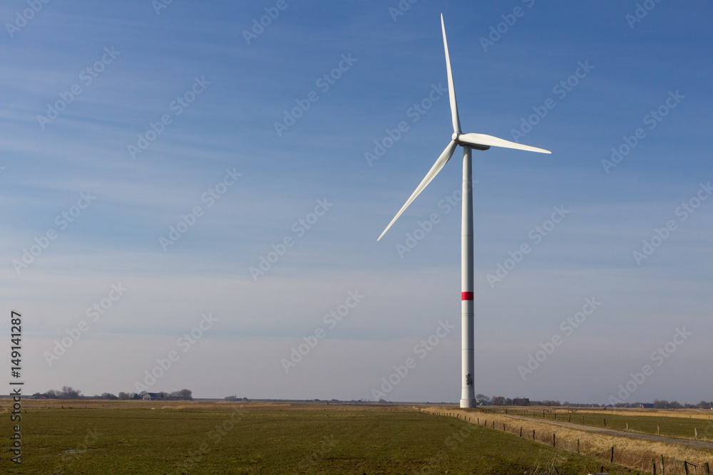 wind wheel on a field with blue sky