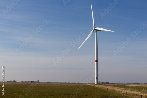 wind wheel on a field with blue sky