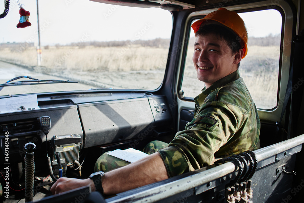 Naklejka premium Portrait of a man, a firefighter, an Asian-Kazakh at work