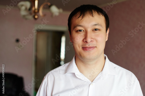 Portrait of a Kazakh young man in the apartment