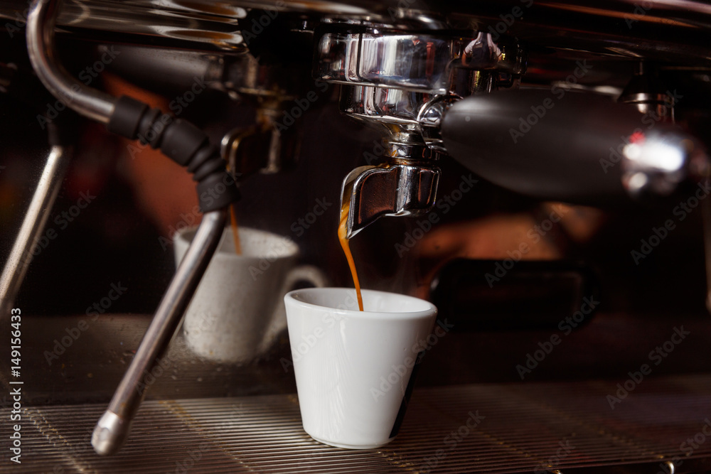 Coffee machine in a cafe pours fresh espresso Coffee machine in a cafe pours fresh espresso