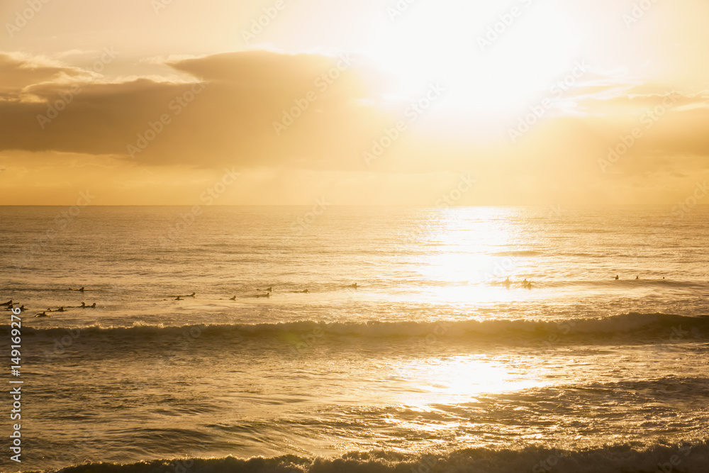 Surfers Paddle Out at Sunrise