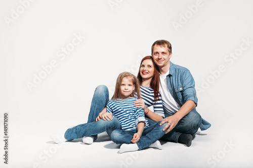 Happy family portrait sitting on white background isolated