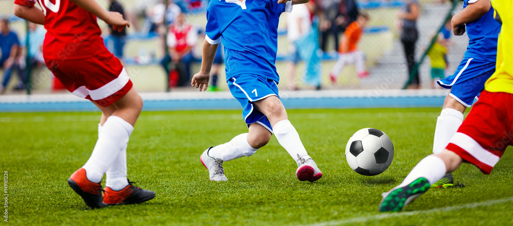 Fototapeta premium Football Soccer Match for Children. Boys Running and Kicking Football Soccer Ball. Kids Playing Soccer Game Tournament