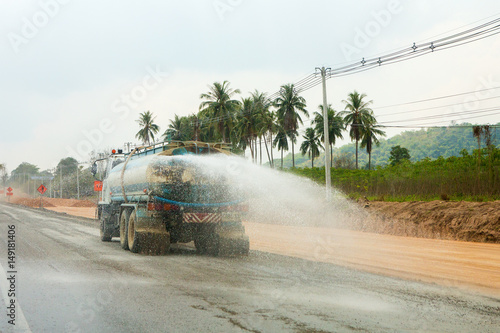 Watering the dust on the street