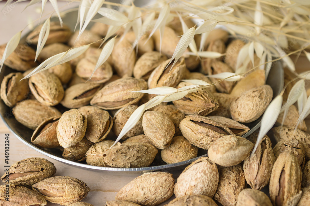 Nuts on the background texture of the wood. Almonds and peanuts. Nuts on the background texture of the wood. Almonds and peanuts.
