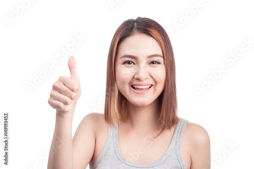 Cheerful lovely girl looking at camera showing thumbs up over white background.