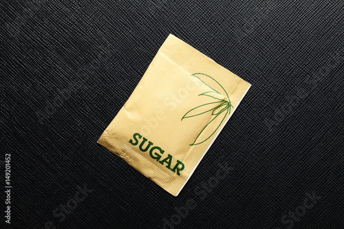 Sugar bag put on the dark background scene.