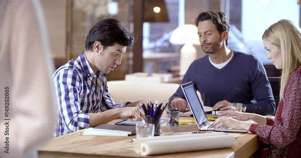 Creative business team work meeting an at agency office. Two young colleagues talking on a design project on tablet. 4k indoor video Creative business team work meeting an at agency office. Two young colleagues talking on a design project on tablet. 4k indoor video