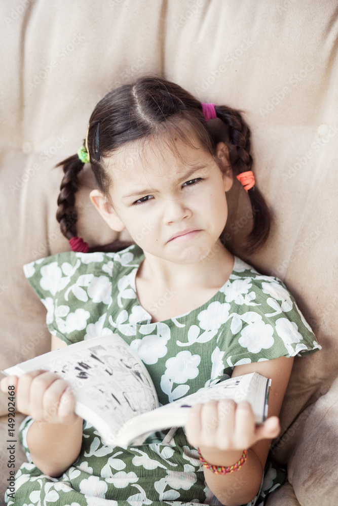 Unhappy Asian girl with a book Unhappy Asian girl with a book