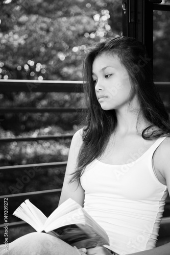 Girl teenager sitting with a book 