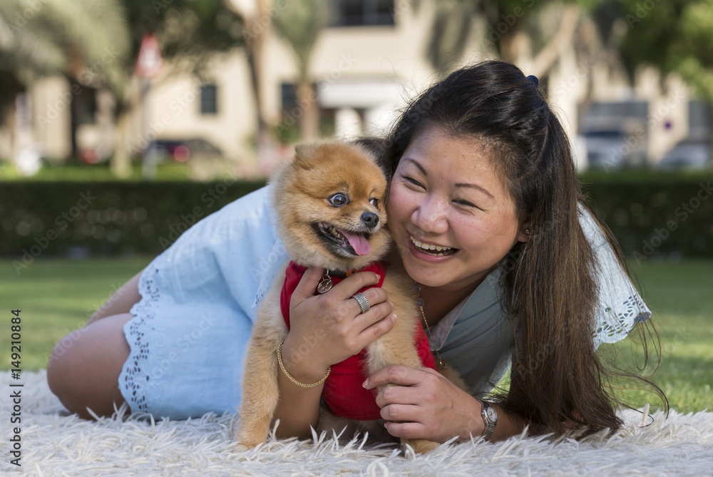 pomeranian and a young chinese lady pomeranian and a young chinese lady