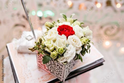 Set of wedding rings in Red and white rose taken closeup. wedding concept. selective focus. flower arrangement box for rings accessories. the ceremony of marriage