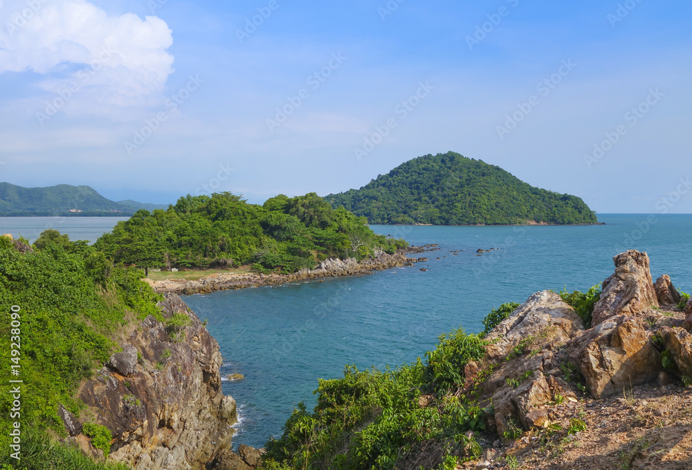 Beautiful aerial view point of tropical sea bay and island, with mountain cliff and rocks in foreground, Noen Nangphaya View Point at Chalerm Burapha Chonlathit Highway, Chanthaburi, Thailand.