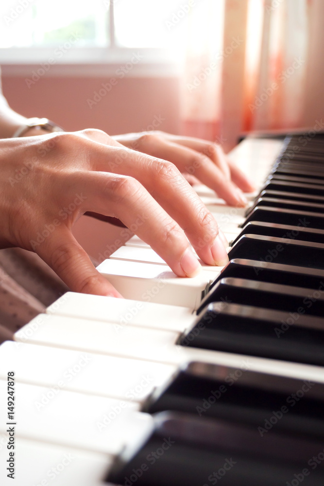 Woman hands playing piano. Music and art background.