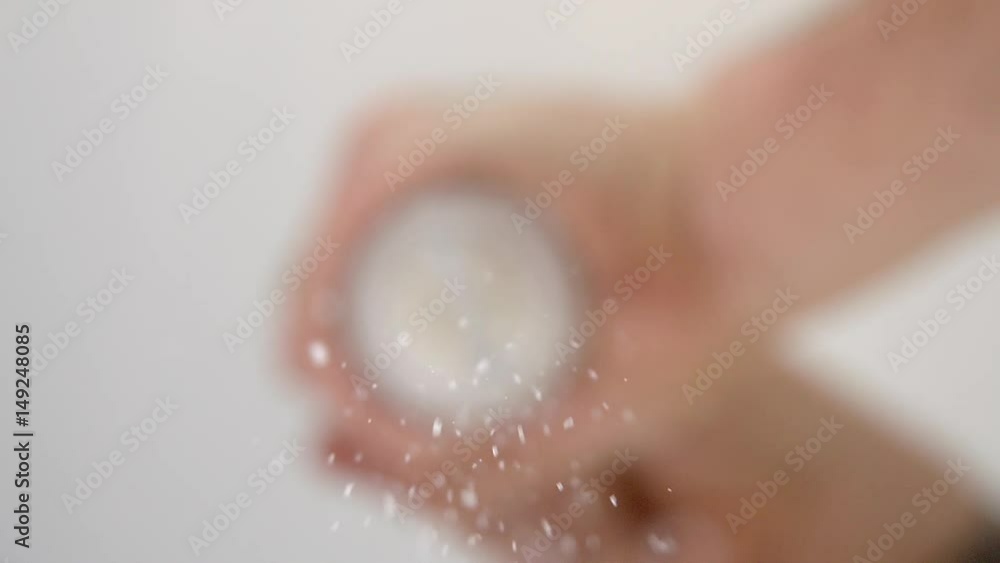 Chef using salt grinder to add salt to his cooking Chef using salt grinder to add salt to his cooking