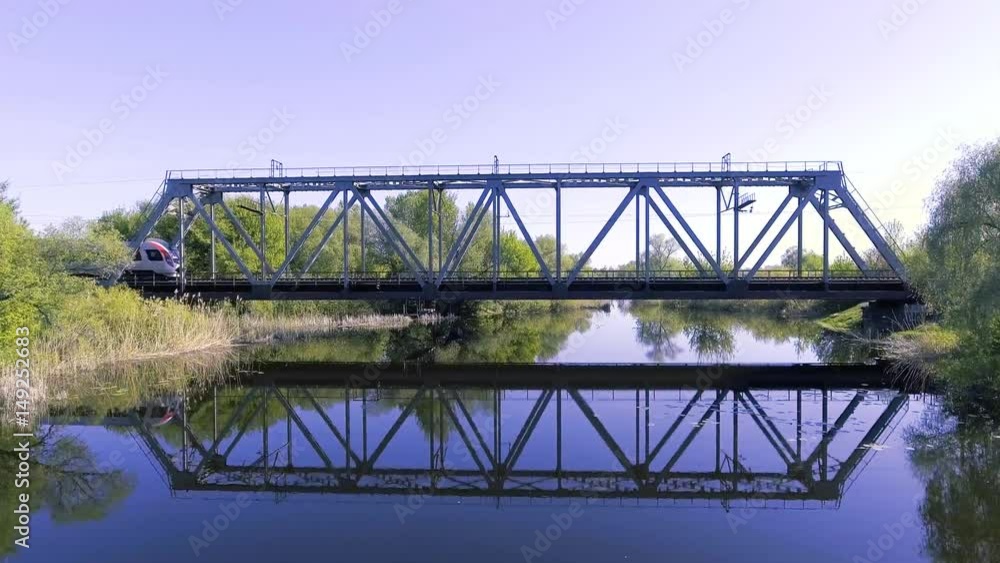 A high-speed train drives a bridge across the river A high-speed train drives a bridge across the river