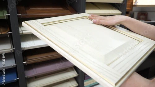 The choice of the facade for furniture. Girl looks through the facade to the kitchen