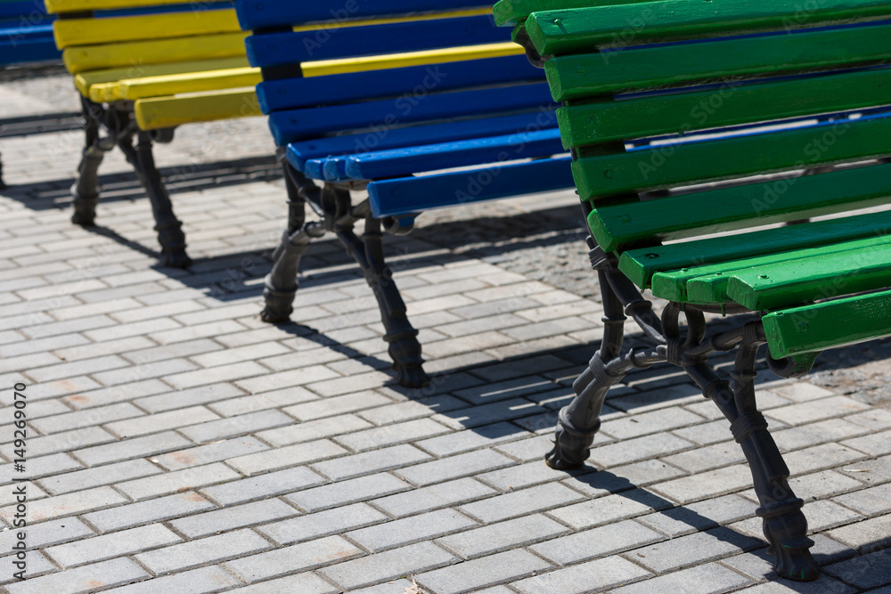 Colorful benches on a sunny summer day. Background. Colorful benches on a sunny summer day. Background.