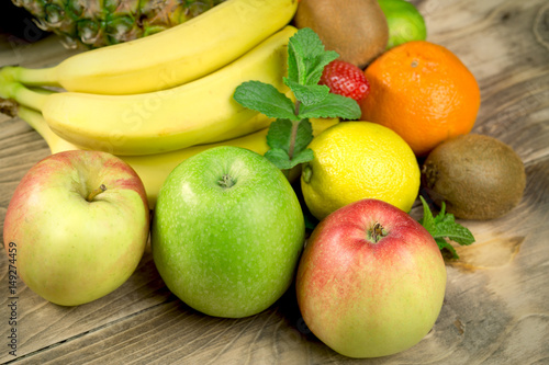 Delicious various fresh and organic fruits on rustic table