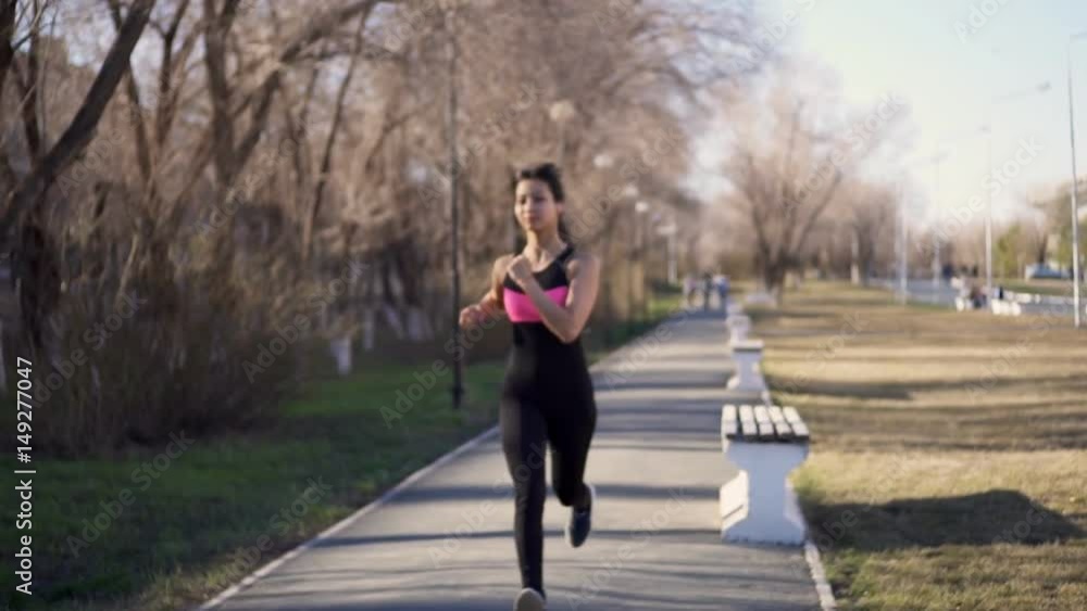 Girl runs in the park in the spring Girl runs in the park in the spring
