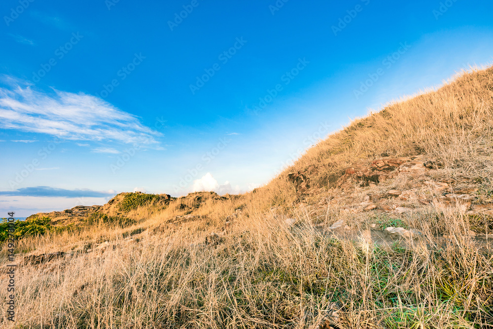 Beautiful rock mountain lanscape and dry meadow in bright blue sky Beautiful rock mountain lanscape and dry meadow in bright blue sky
