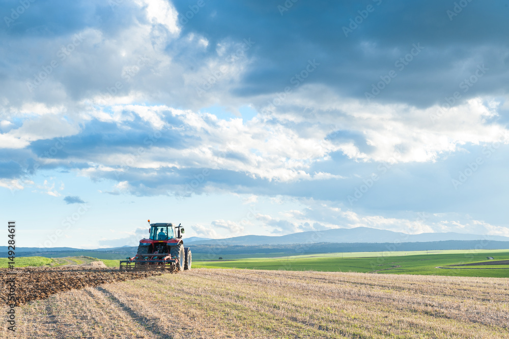 Fototapeta premium tractor in the lands along with gear for work.
