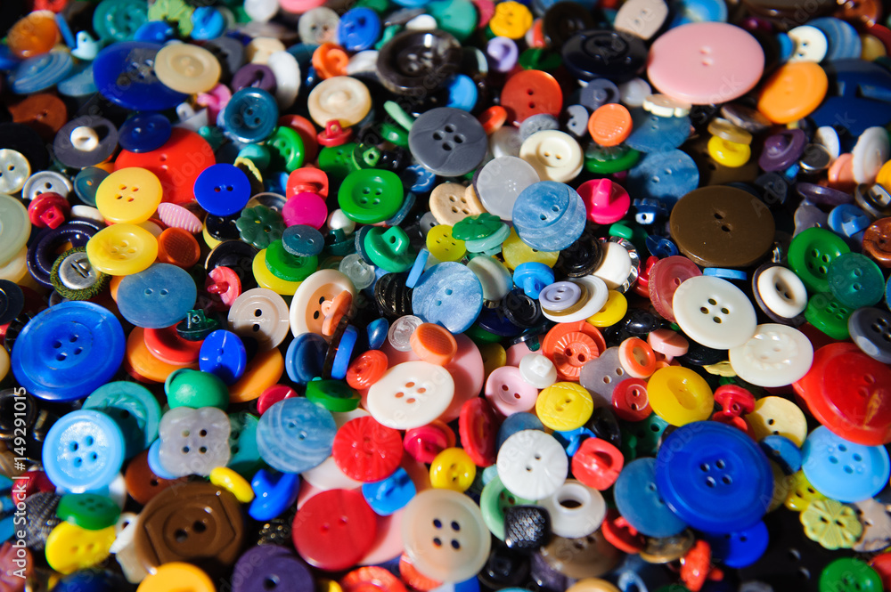 Lot of colorful plastic clothing buttons. Many small round vintage buttons pattern background Lot of colorful plastic clothing buttons. Many small round vintage buttons pattern background