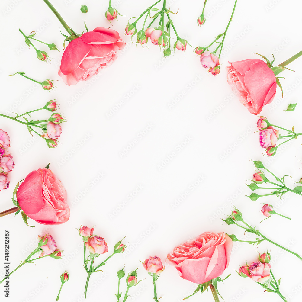 Round frame made of purple roses and buds on white background. Flat lay, top view. Floral pattern Round frame made of purple roses and buds on white background. Flat lay, top view. Floral pattern